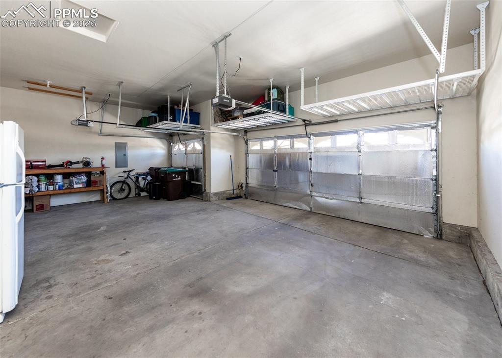 Image 43 of 50: 3-car garage with ceiling storage racks!