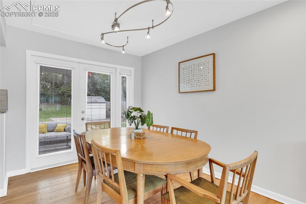 Image 13 of 50: Dining space featuring french doors and light wood finished floors