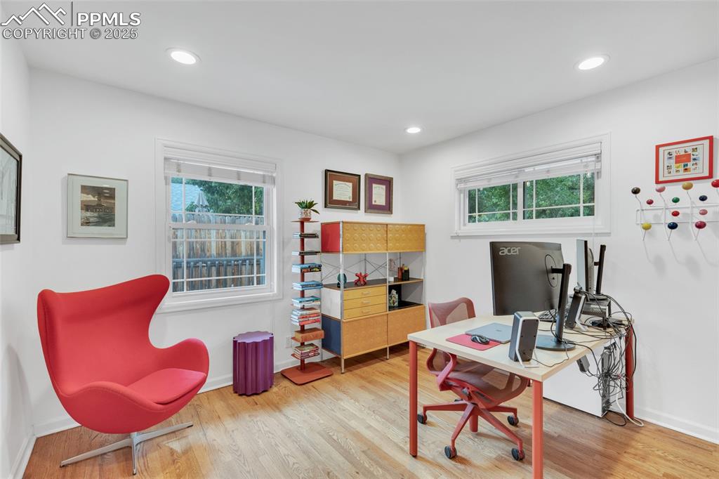 Image 23 of 50: Office featuring healthy amount of natural light, wood finished floors, and