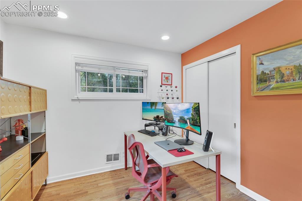 Image 24 of 50: Home office with light wood-style flooring and recessed lighting