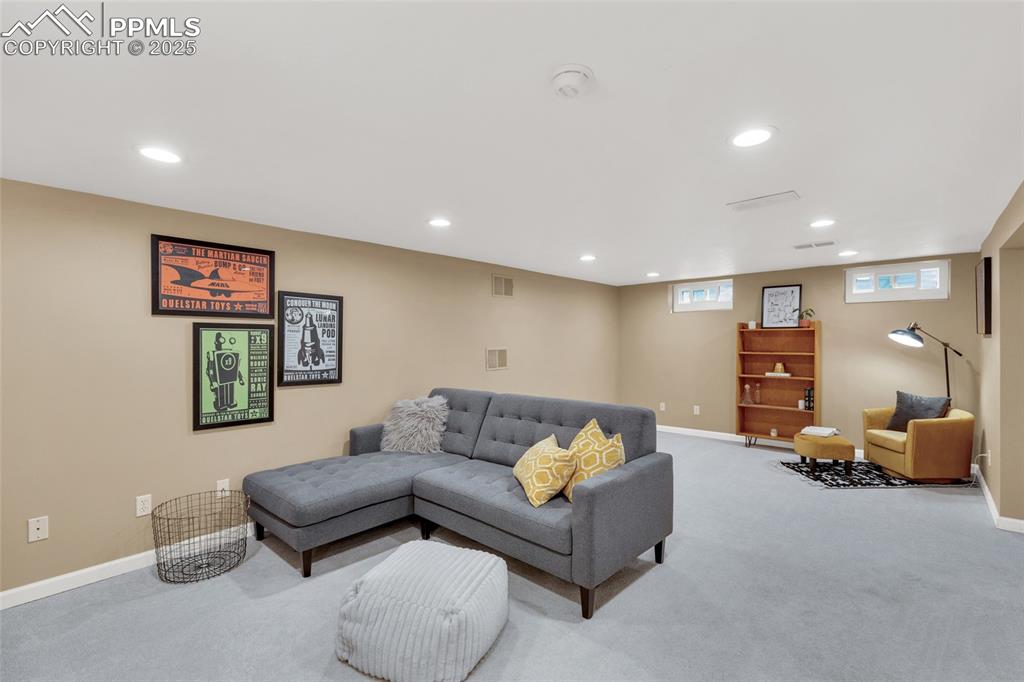 Image 26 of 50: Carpeted living room with recessed lighting