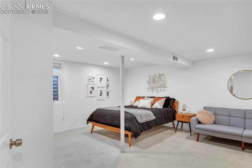 Image 28 of 50: Bedroom featuring light colored carpet and recessed lighting