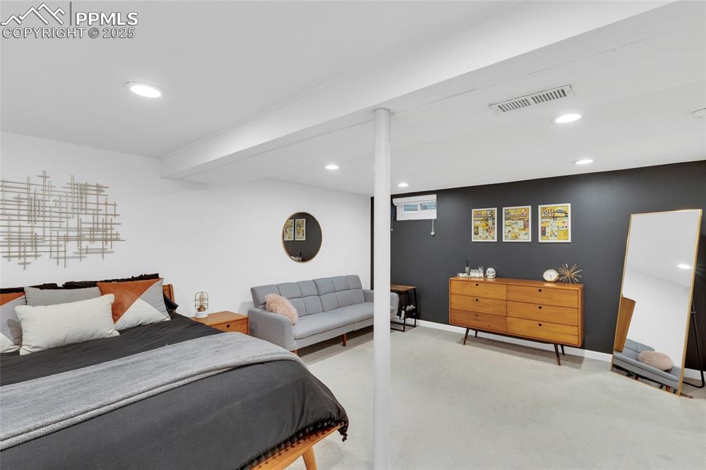 Image 29 of 50: Bedroom featuring recessed lighting and light colored carpet
