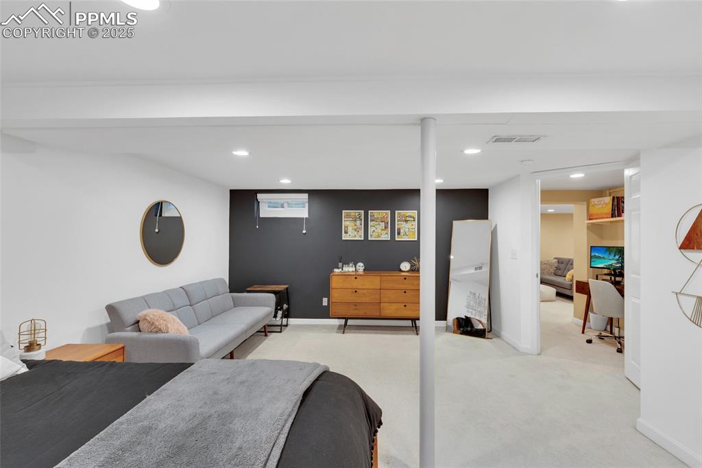 Image 32 of 50: Living area featuring recessed lighting and light carpet