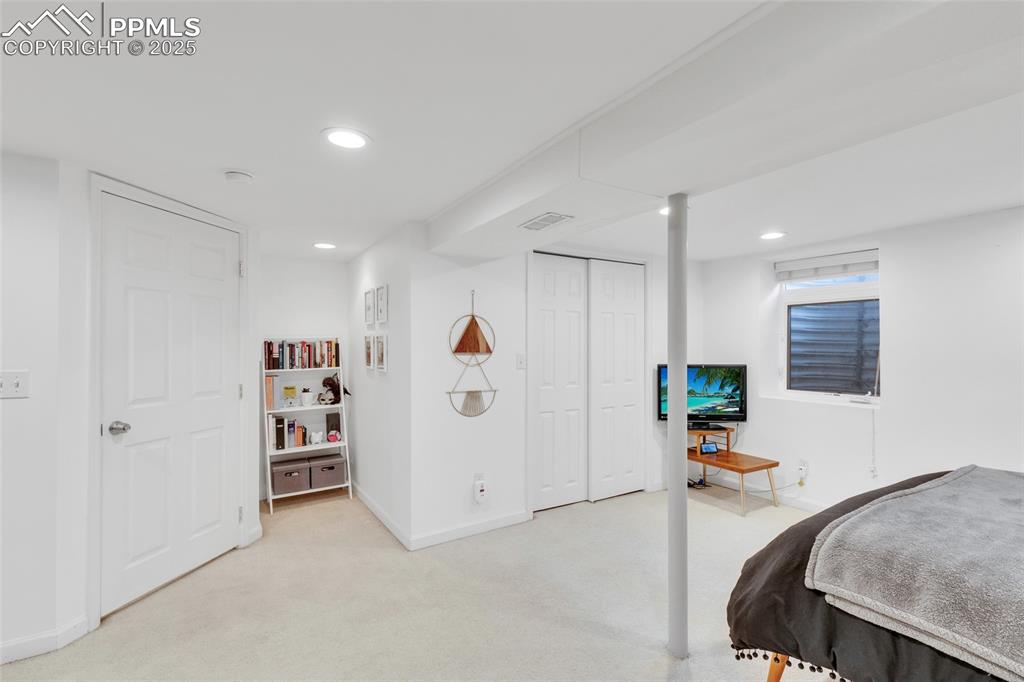 Image 33 of 50: Bedroom with light colored carpet, recessed lighting, and a closet