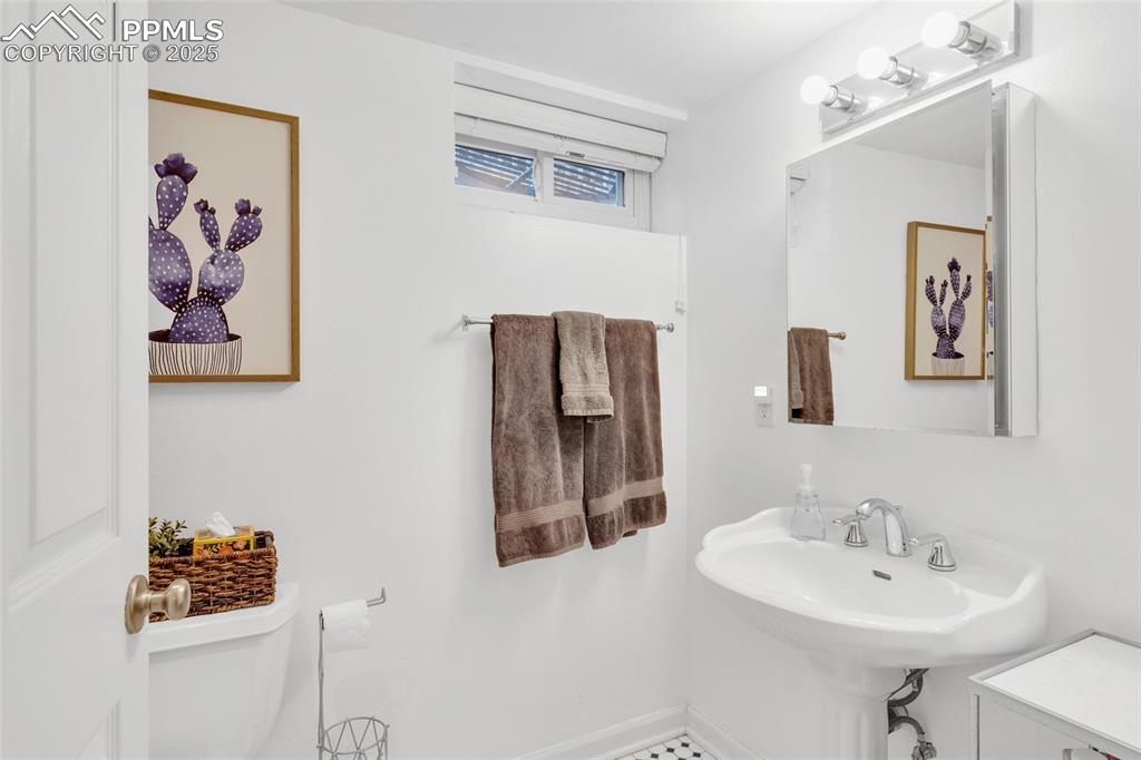 Image 34 of 50: Half bathroom with toilet and baseboards