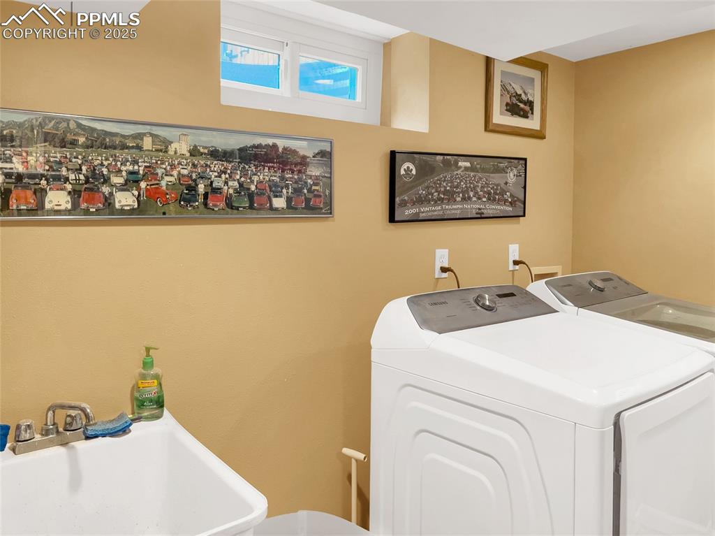 Image 39 of 50: Laundry room featuring independent washer and dryer