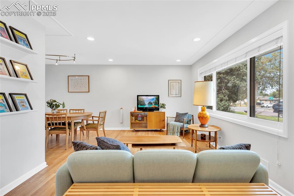 Image 8 of 50: Living room with recessed lighting and wood finished floors