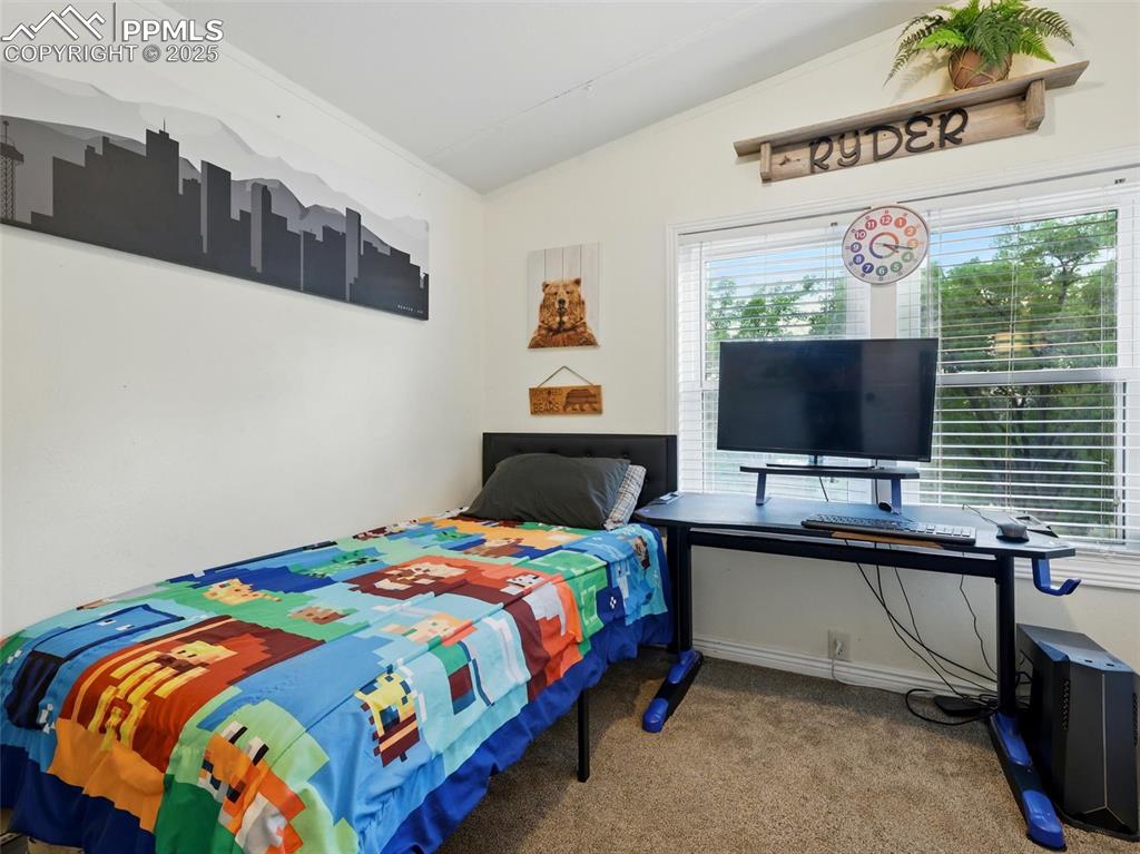 Image 23 of 45: Fourth Bedroom featuring vaulted ceiling and carpet floors