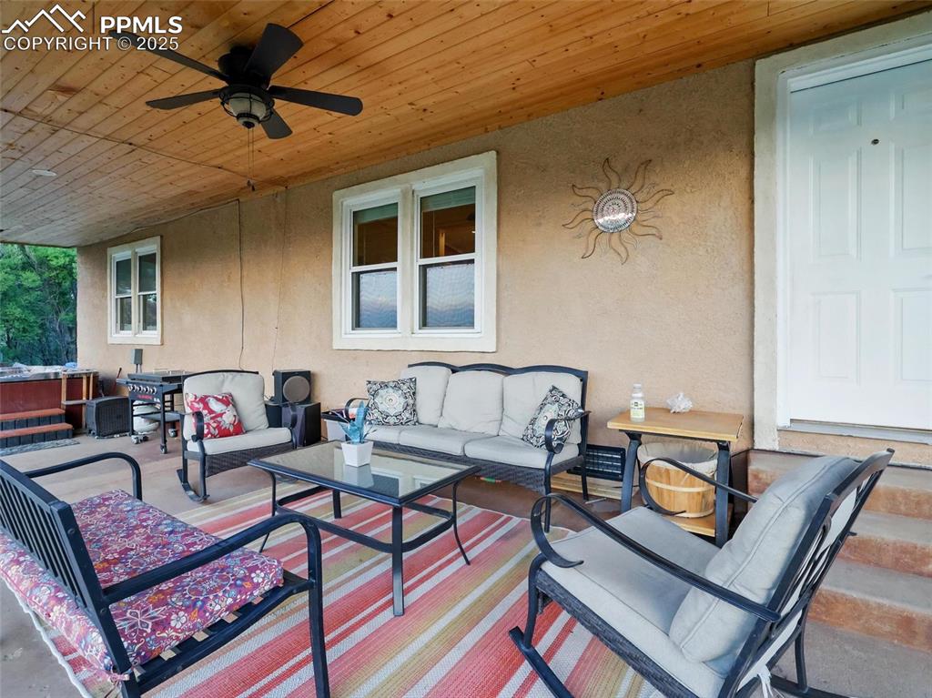 Image 29 of 45: View of patio / terrace with outdoor lounge area, a ceiling fan, and a jacu