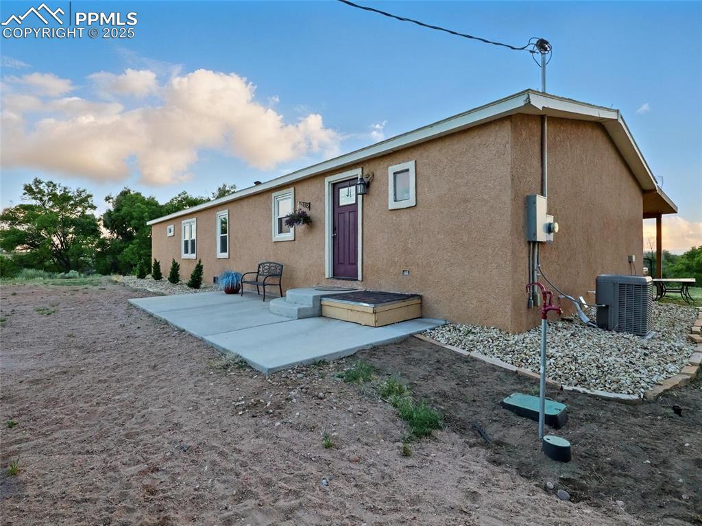 Image 43 of 45: Front view of house featuring stucco siding, central air condition unit, an