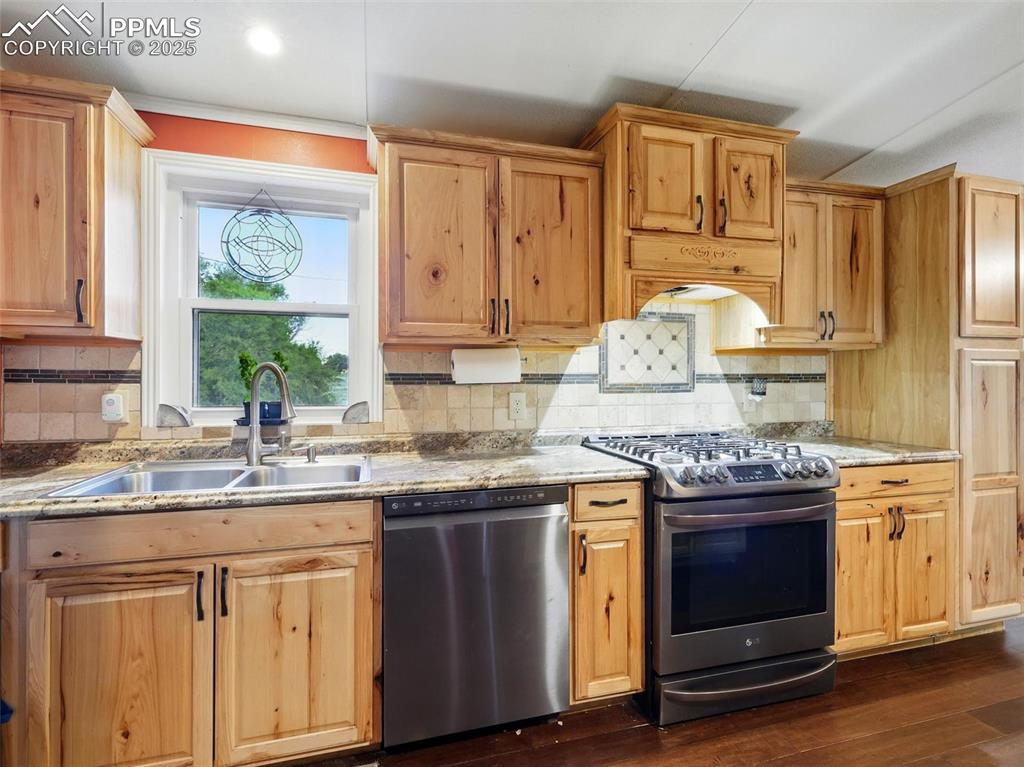 Image 7 of 45: Kitchen featuring stainless steel appliances and hickory cabinets