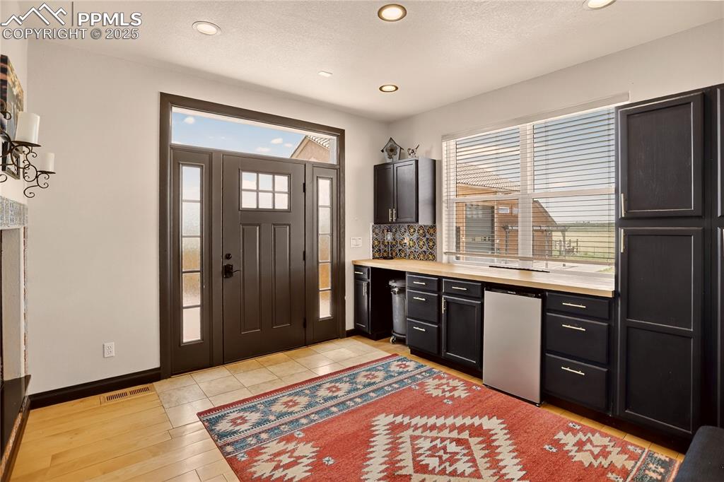 Image 17 of 46: Mudroom w/ fireplace & built-ins