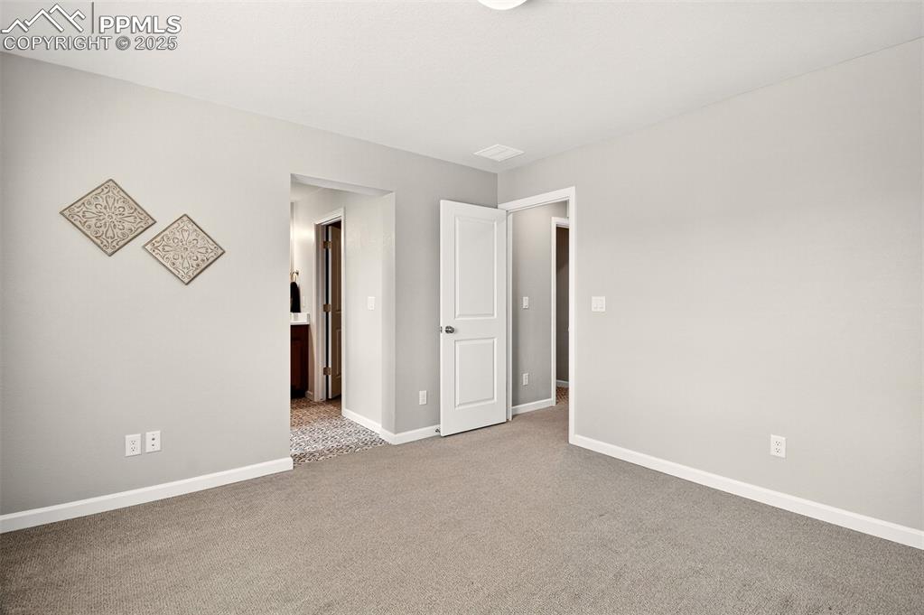 Image 13 of 29: Spacious primary suite with attached bathroom. 
