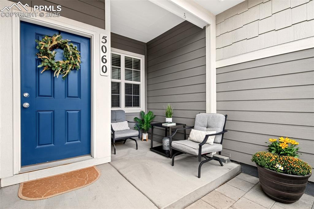 Image 2 of 29: Charming covered front patio.
