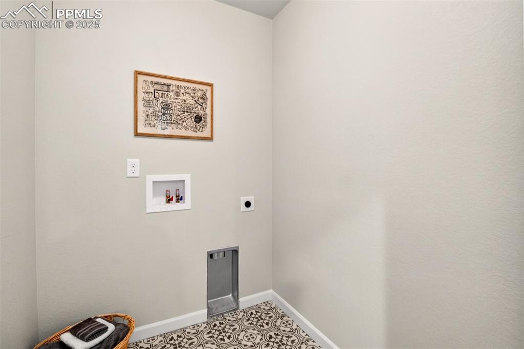 Image 22 of 29: Convenient 6x8 upper level laundry room with designer tile flooring.