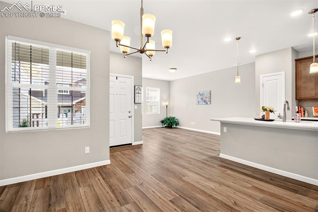 Image 3 of 29: Entry showcasing luxury vinyl plank flooring throughout the main level alon