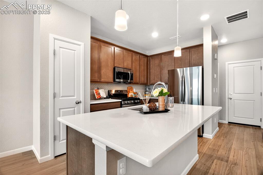 Image 5 of 29: Kitchen featuring Stainless Steel appliances w/gas stove, Quartz countertop