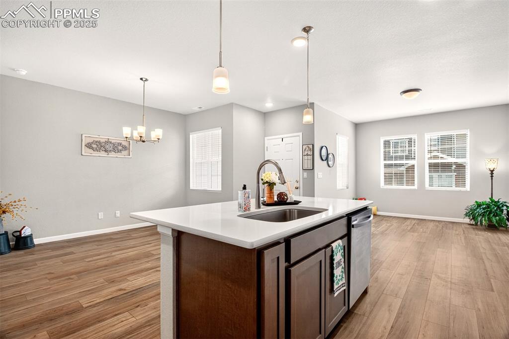 Image 6 of 29: Kitchen island featuring an oversized stainless steel sink and breakfast ba