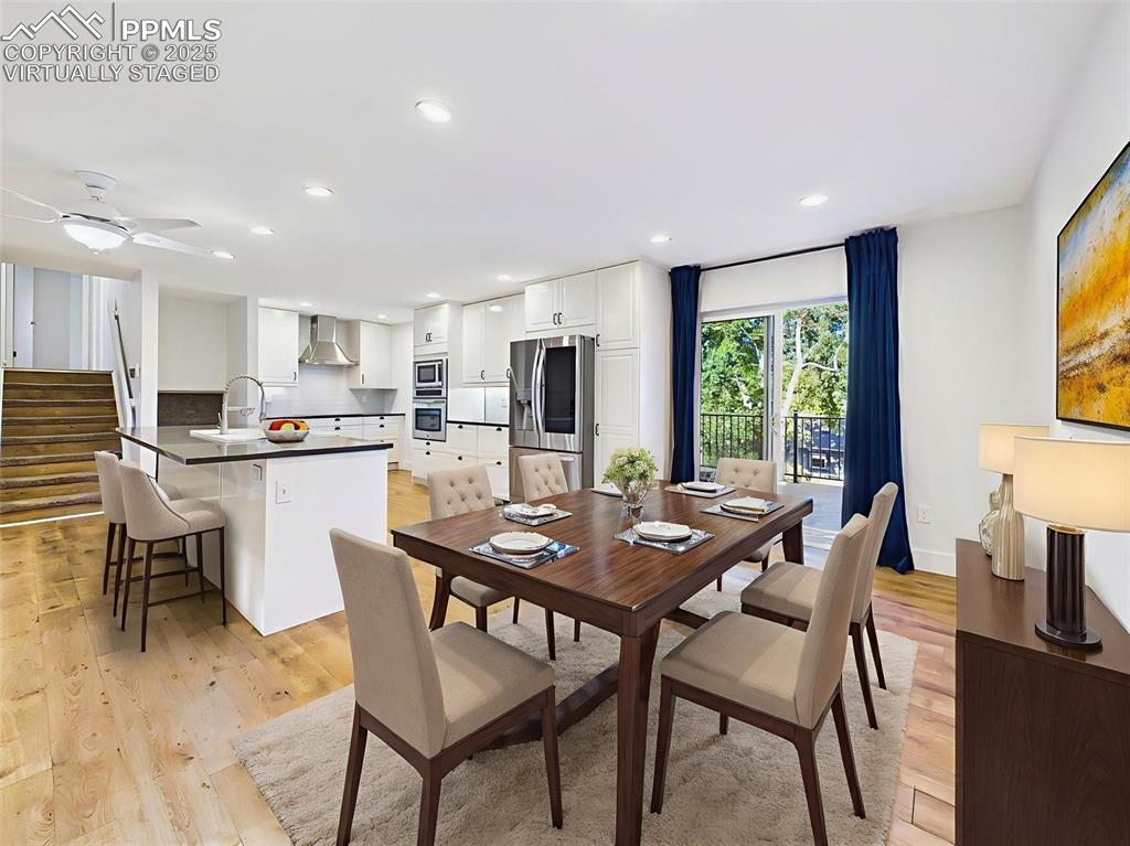 Image 13 of 50: Virtually staged to show a stylish dining setup, this area connects seamles