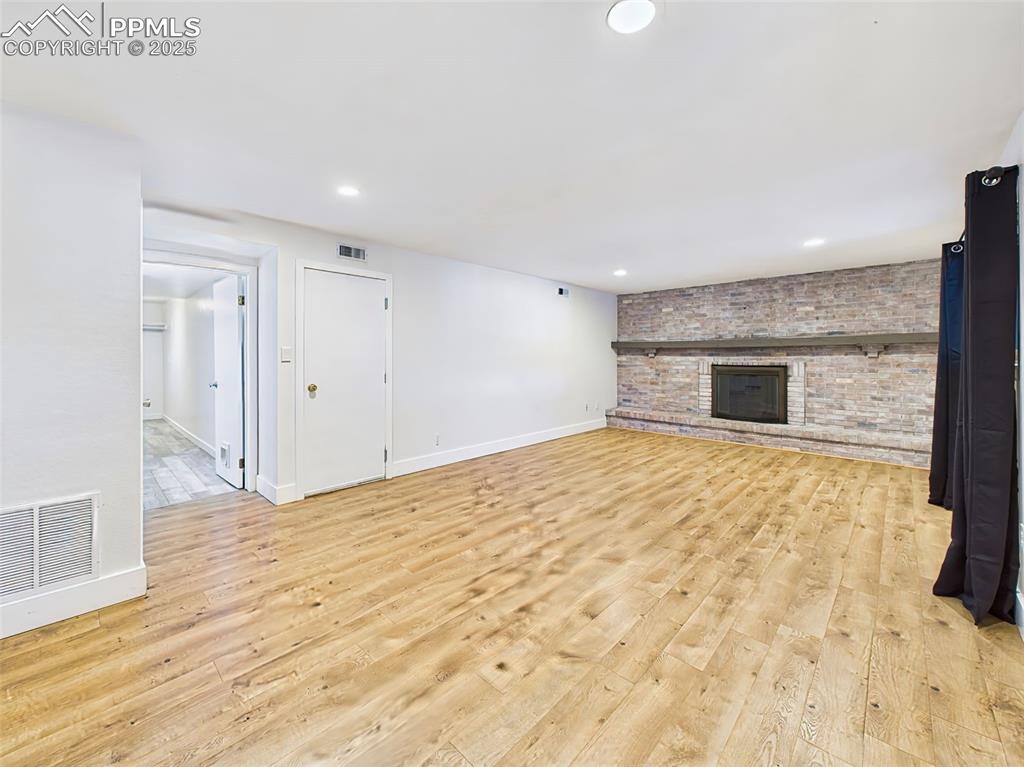 Image 18 of 50: Bright and open lower-level space, perfect for relaxing or gathering, with 