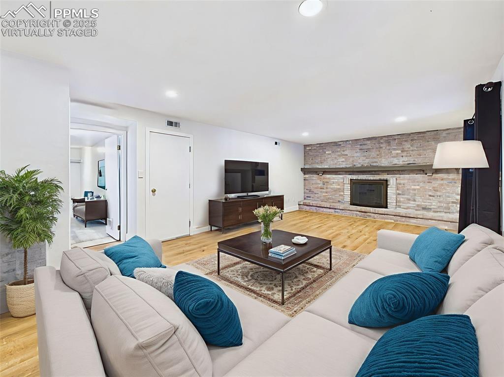 Image 19 of 50: Virtually staged view highlights room for ample seating and a media setup, 