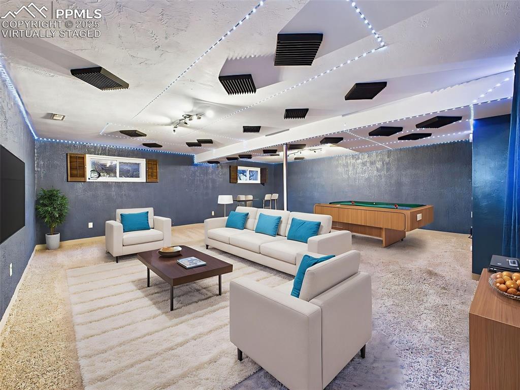 Image 23 of 50: Virtually staged to show a fun and functional rec room, this finished basem