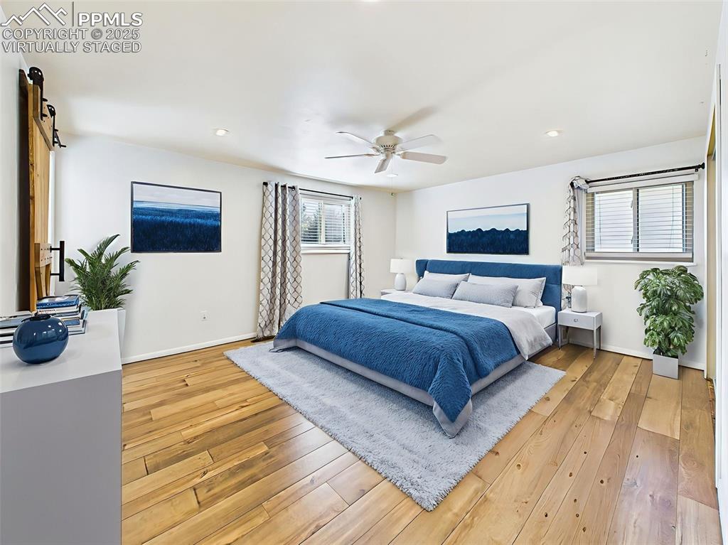 Image 29 of 50: Virtually staged to show a serene sleeping space, this bedroom features neu