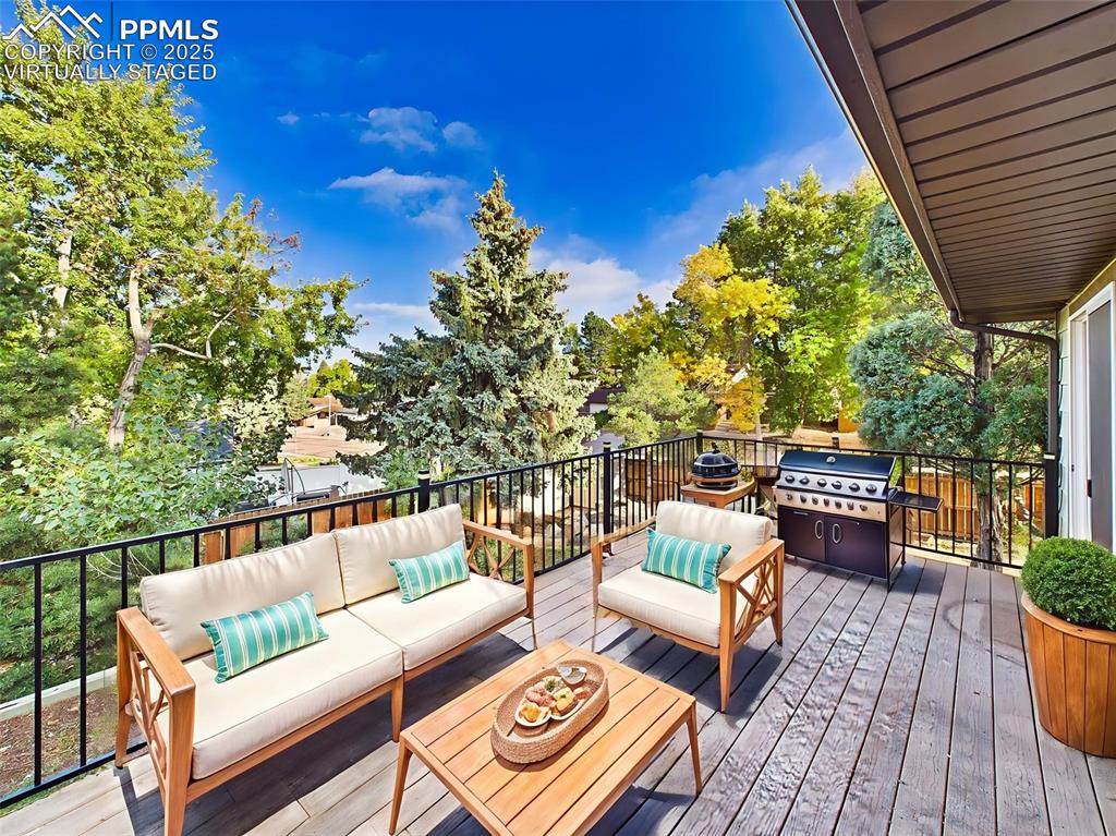Image 46 of 50: Virtually staged to show a cozy outdoor lounge setup, this elevated deck is