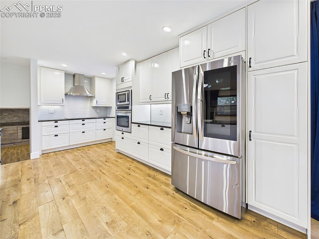 Image 8 of 50: Stainless steel French door refrigerator is flanked by tall pantry cabinets