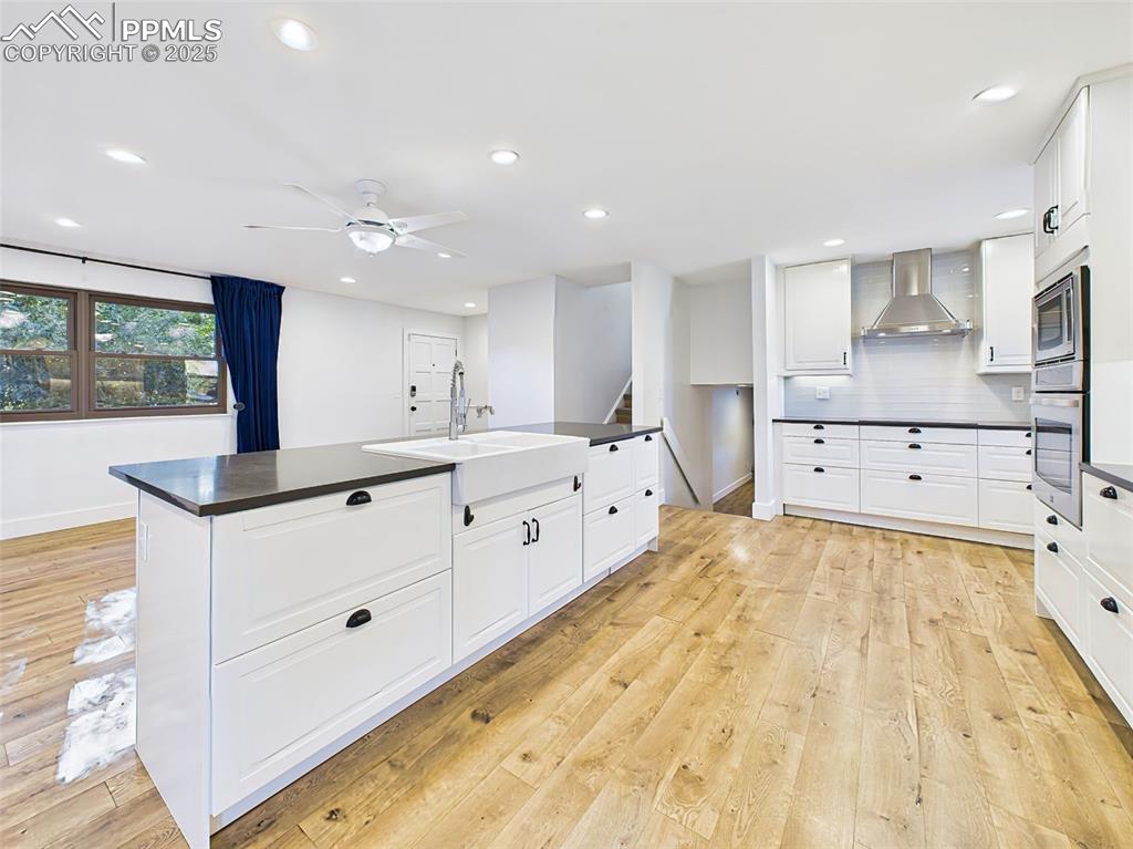 Image 9 of 50: Wide-angle view highlights the kitchen island’s central role in this open-c