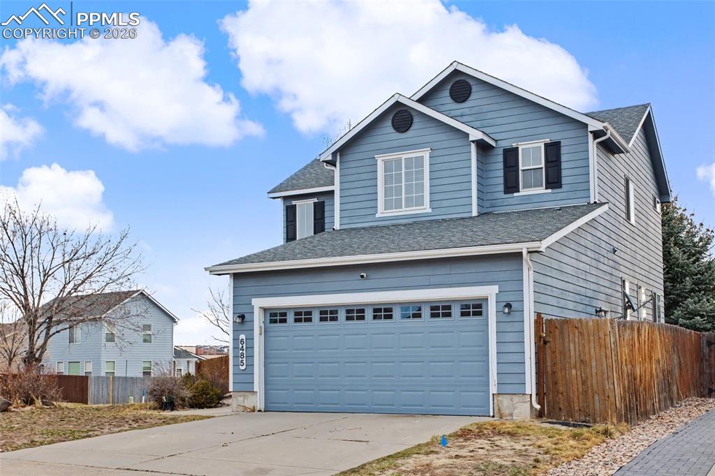 Image 10 of 33: Traditional home featuring concrete driveway, a garage, and a shingled roof
