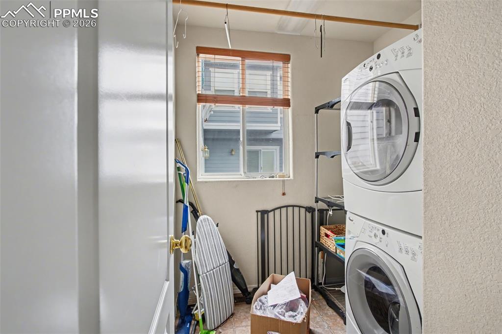 Image 18 of 33: Laundry area featuring stacked washer / drying machine