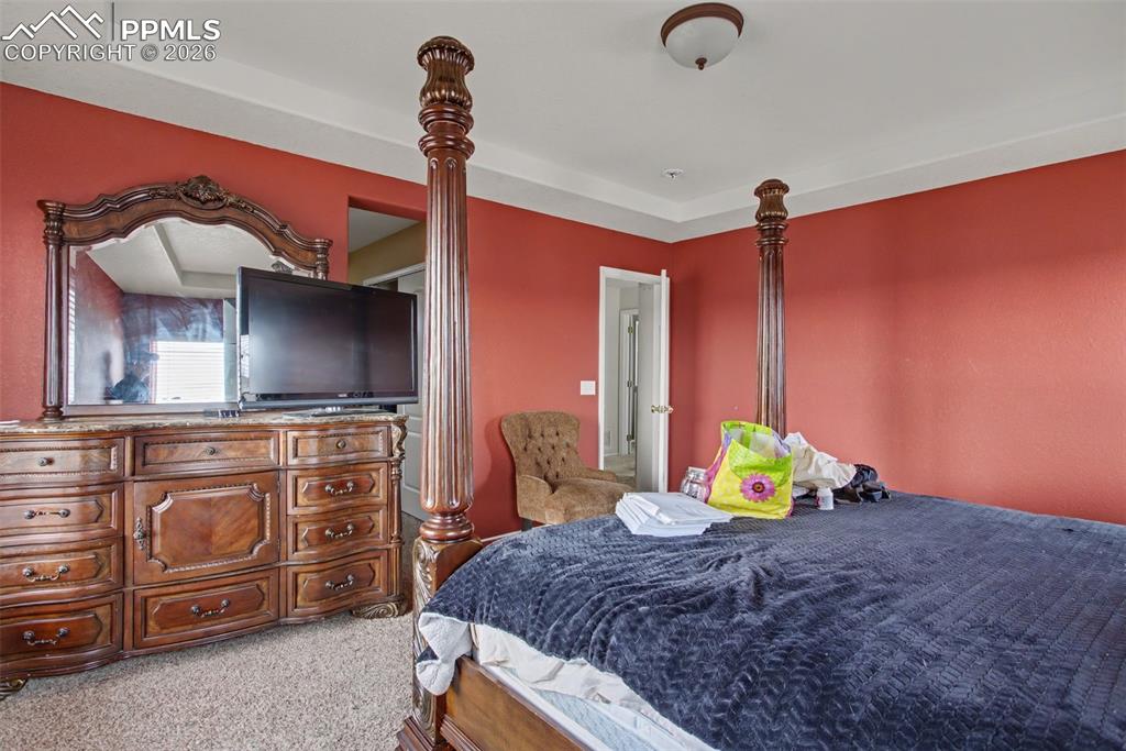 Image 20 of 33: Bedroom featuring light colored carpet