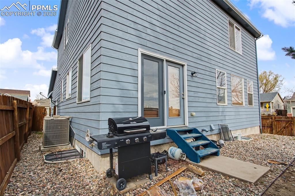 Image 31 of 33: Rear view of property featuring a fenced backyard and a patio