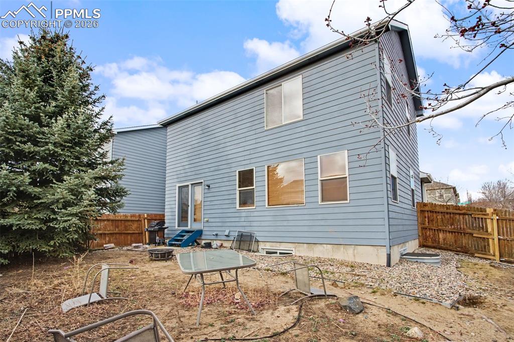 Image 33 of 33: Rear view of property featuring a fenced backyard and a patio