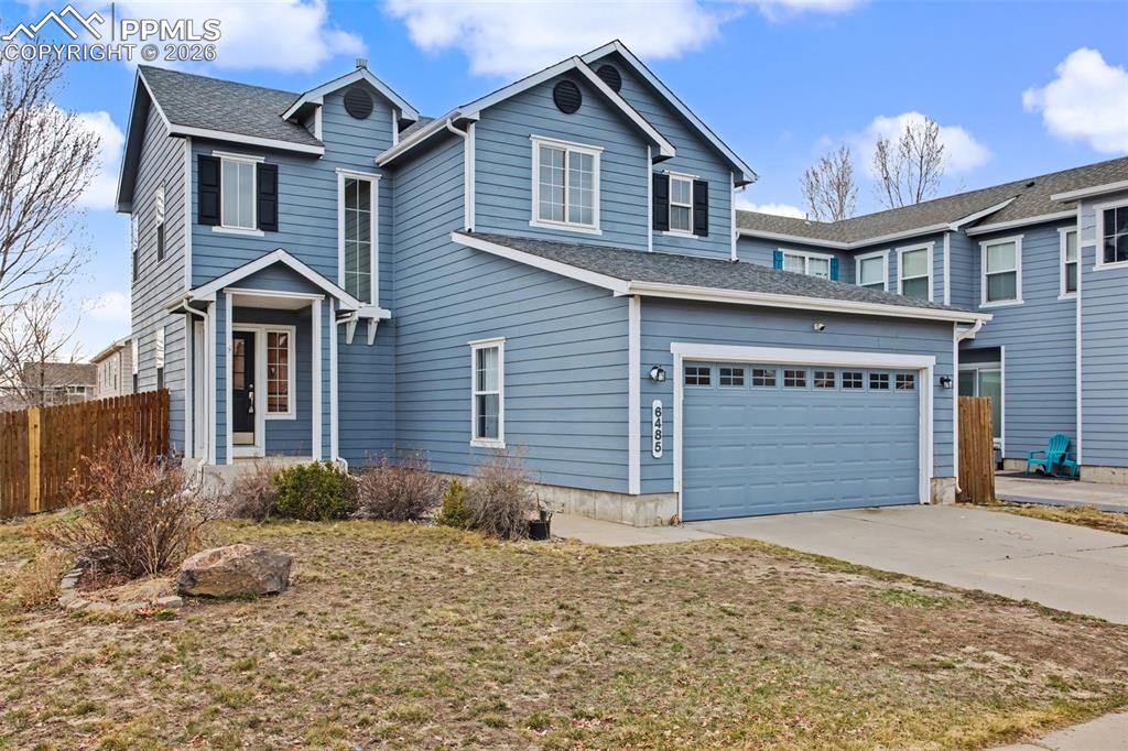 Image 9 of 33: Traditional home featuring driveway and roof with shingles