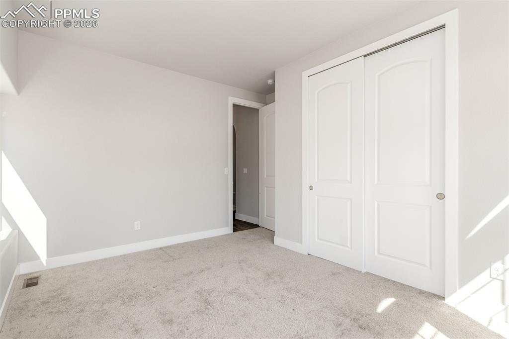 Image 26 of 46: Unfurnished bedroom with carpet flooring and a closet