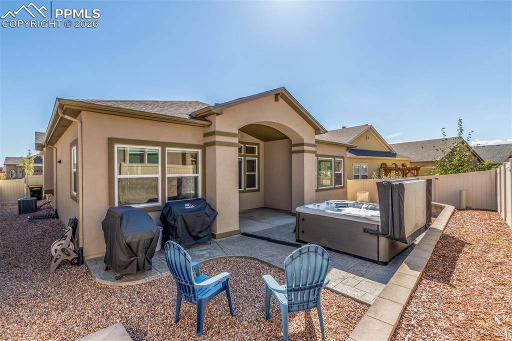 Image 35 of 46: Back of house with a fenced backyard, a patio area, stucco siding, and a ho