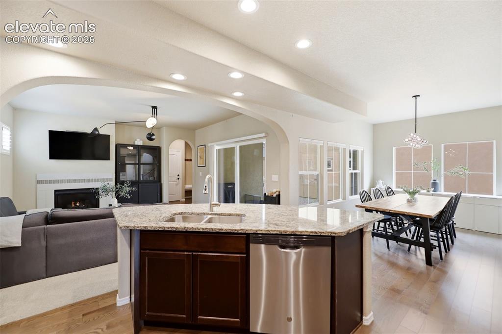Image 13 of 48: Open concept floorplan with a slider leading out to the covered side porch