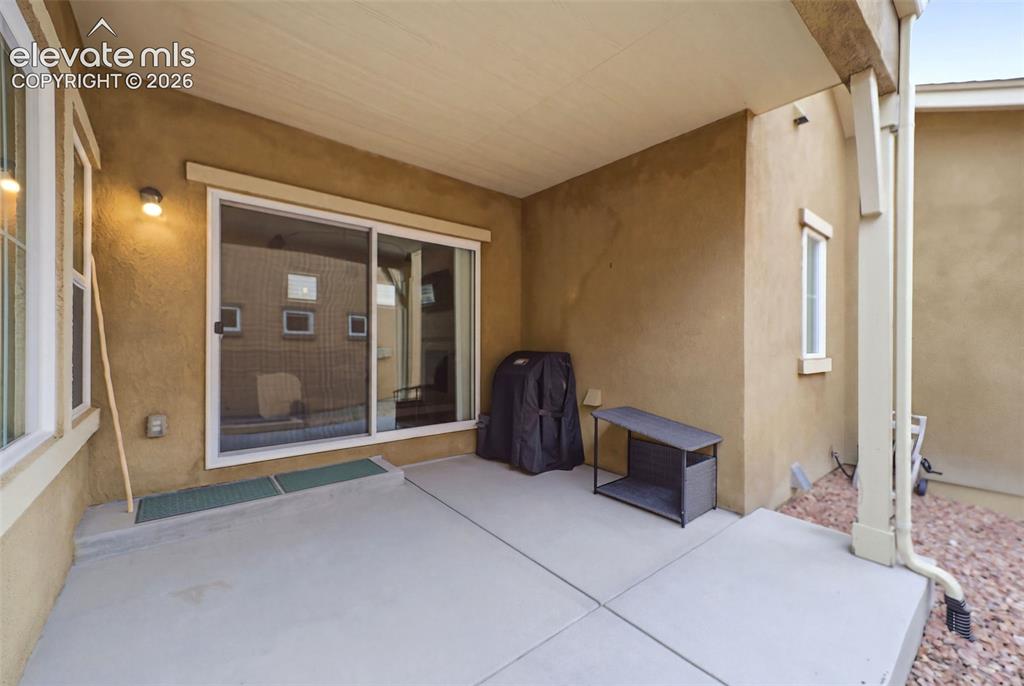 Image 16 of 48: Covered patio with concrete flooring, stucco exterior, and sliding glass do