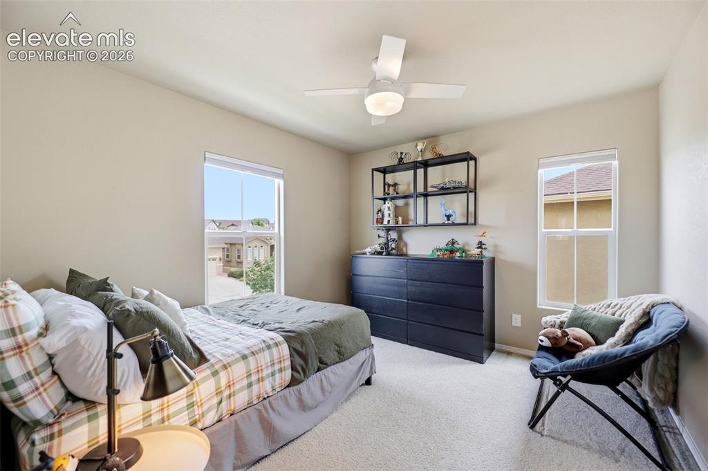 Image 24 of 48: Recessed ceiling lighting, a modern ceiling fan, and light-toned carpeting