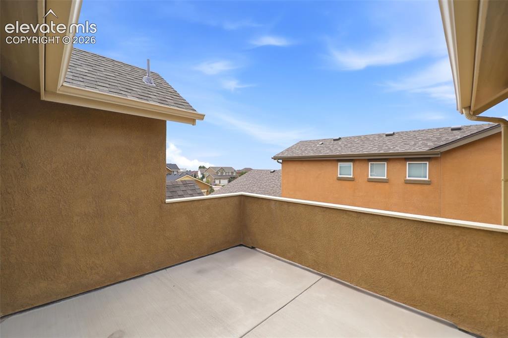 Image 28 of 48: Exterior balcony with stucco walls and concrete flooring