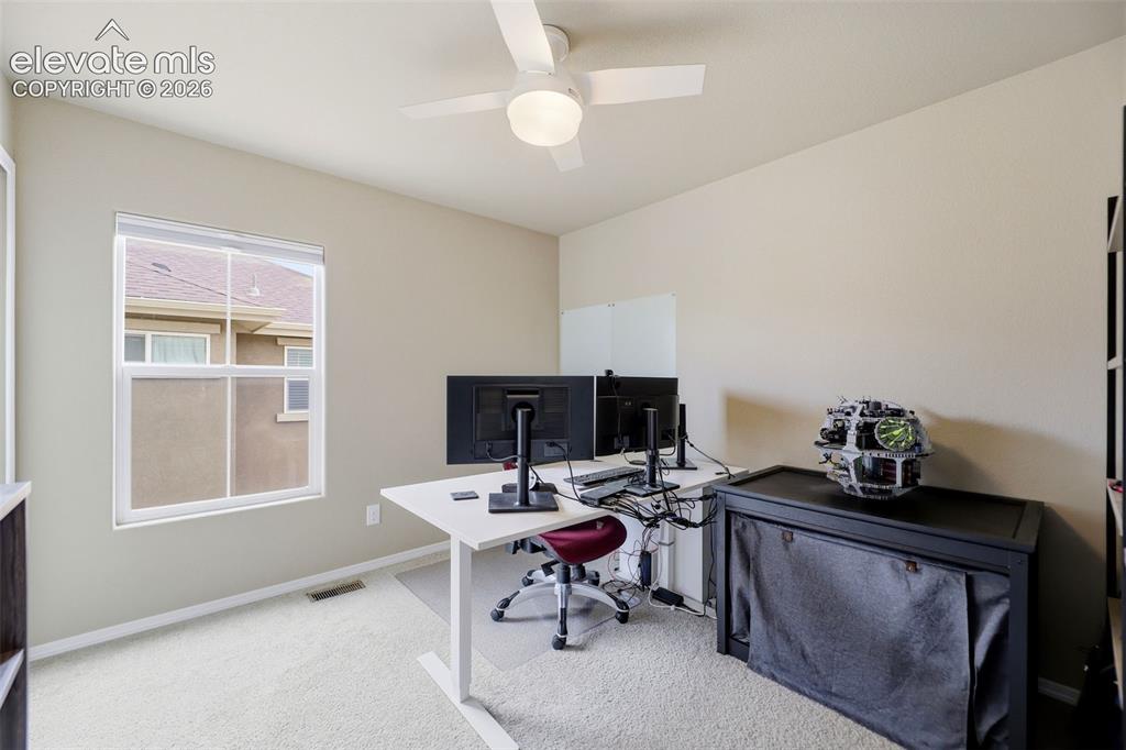 Image 33 of 48: Neutral-toned walls complement the carpeted flooring