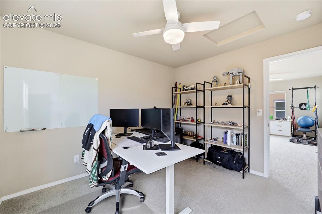 Image 34 of 48: White ceiling fan with integrated lighting, wall-mounted whiteboard, and li