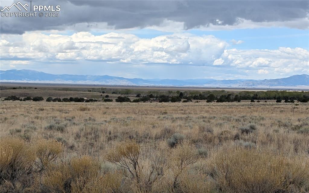 Image 2 of 4: View of mountain backdrop with rural landscape