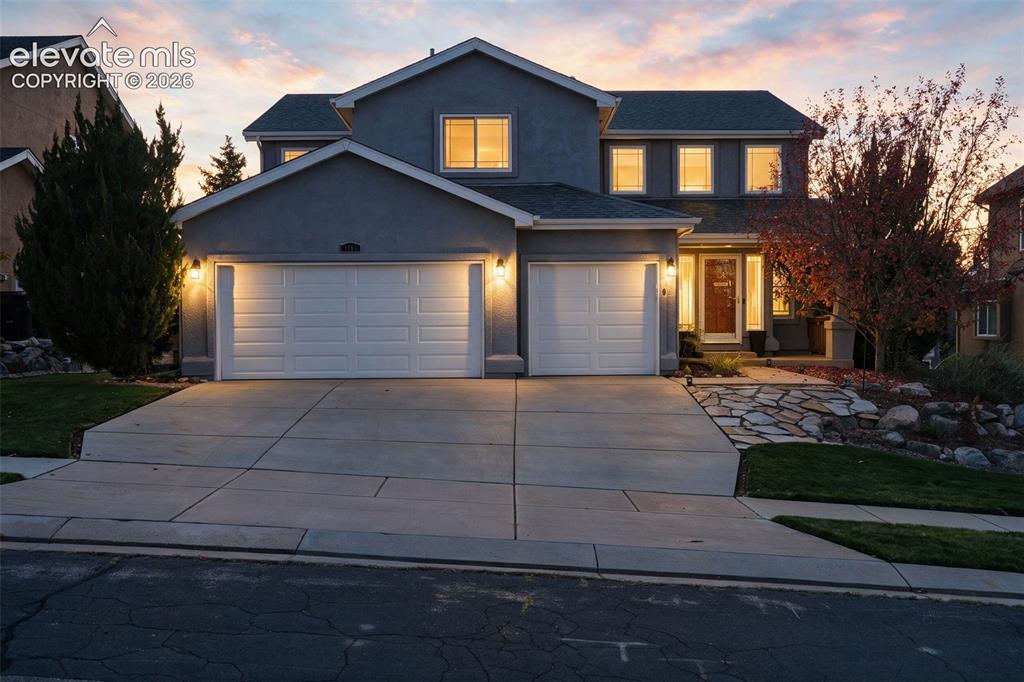Image 1 of 50: Two-story stucco exterior with a multi-pane front door, a multi-car drivewa
