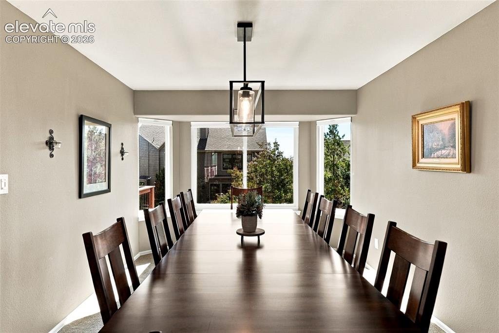 Image 10 of 50: Dining area featuring a bay window, recessed ceiling, and a contemporary li