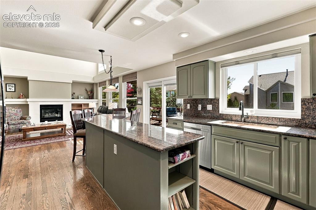 Image 13 of 50: Kitchen featuring an island with stone countertops, recessed lighting, and