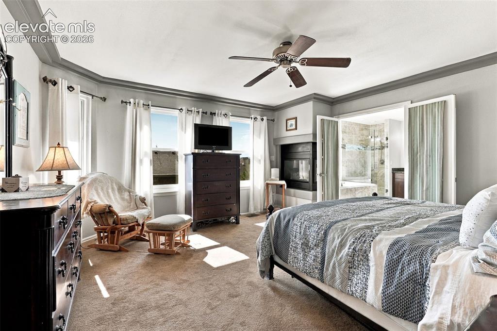 Image 18 of 50: Tray ceiling, ceiling fan, multiple windows with natural light, built-in fi
